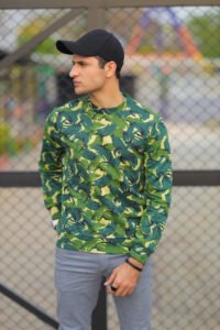 man-wearing-green-camouflage-shirt-stands-front-fence